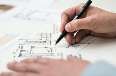 pexels photo 1109541 1109541 Close-up of hand drawing intricate technical designs on blueprint with pen, ideal for engineering or architecture themes.